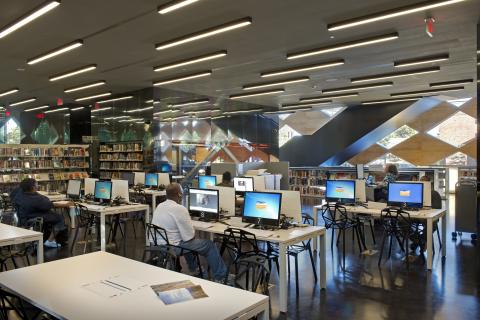 room filled with tables and desktop computers