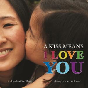 Book cover of A Kiss Means I Love You. Photograph of a child kissing a caregiver on the cheek.
