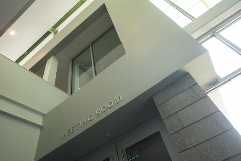 gray wall with "meeting room" plaque
