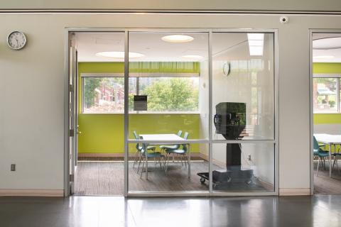 four person meeting room with table and blue chairs