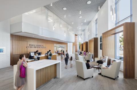 overview of front desk area with main desk and white plush seating