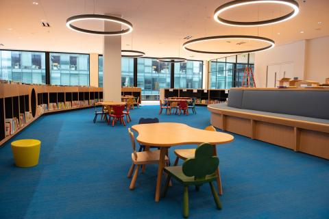room with low bookshelves and abstract shaped tables