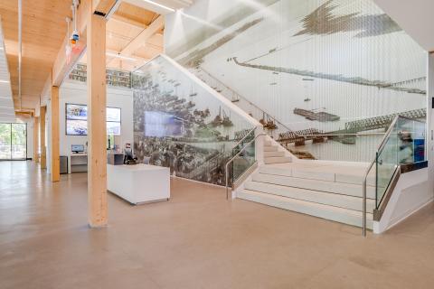 stairwell with a large black and white mural of waterfront