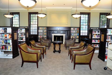 room with fireplace and two rows of plush chairs