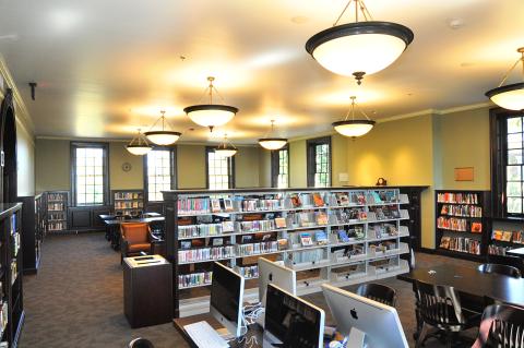 room with book stacks and tables with computers