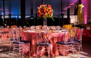 Round table with chairs and a tall colorful floral centerpiece
