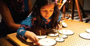 A child manipulates gears in the children's exhibit Leonardo's Lab