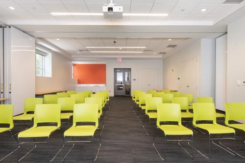 large room with lime green chairs set up classroom style