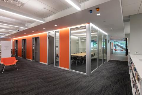 block of meeting rooms in the middle of a space