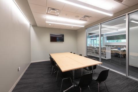 room with glass wall and a long table with chairs