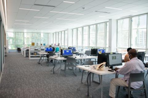 room filled with tables and desktop computers