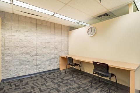 two person meeting room with desk pushed against the wall