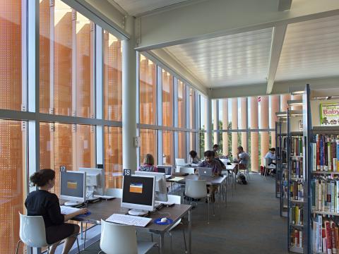 tables of computers against glass windows