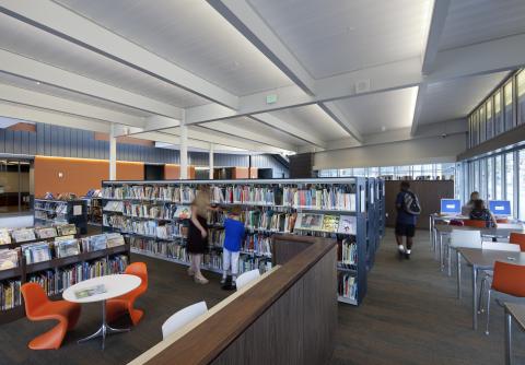 room with bookshelves and low tables and chairs