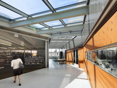 Hallway with room of books on one side and display case on the other