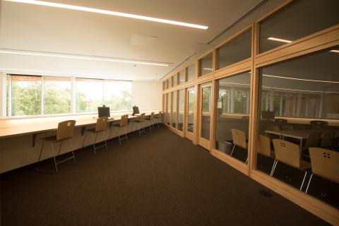 high top seating along a wall with meeting rooms behind