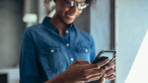 Woman typing on a smartphone