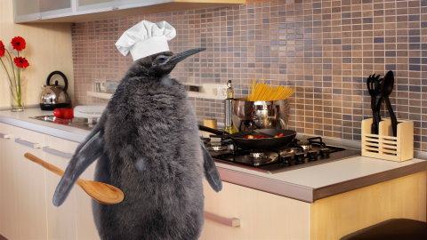 A photoshopped picture of Pesto the Penguin placed in a kitchen "cooking" pasta